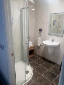 a bathroom with a shower and a sink at Imperial Hotel in Tralee