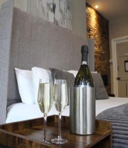 Una botella de vino y dos copas en una mesa. en The Mitre Hotel en Mánchester