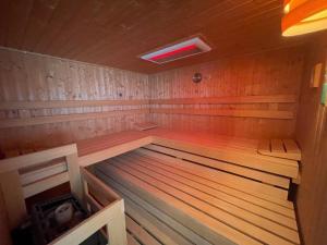 an empty wooden sauna with a red light in it at Ferienwohnung "Vita e Vino" in Freinsheim