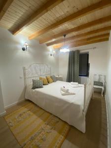 - une chambre avec un grand lit blanc dans l'établissement Casinha Pôr do Sol, à Aldeia das Dez