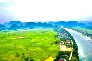 an aerial view of a river with mountains in the background at Happy field homestay in Phong Nha