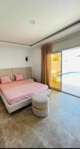 a bedroom with a large bed with pink pillows at Dar Adam in Djerba