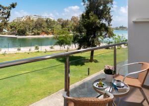 a balcony with a table and chairs and a view of the water at Kaya Side in Side