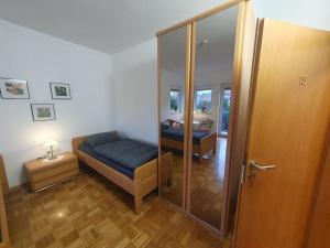 a small room with a bed and a glass door at ABM Apartment 15 in Zwingenberg
