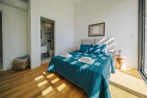 a bedroom with a blue bed with blue pillows at Oasis Villa 6 in Khlorakas