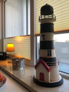 a model of a lighthouse sitting on a table at Fewo Sandkueste in Heiligenhafen