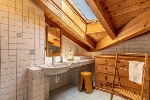 a bathroom with a sink and a wooden ceiling at Al Borgo, Taio Ospitar in Taio +39 photos