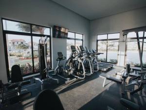 a gym with a bunch of treadmills and ellipticals at Gold coast beautiful house with private pool in Palm-Eagle Beach