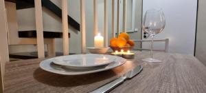 a table with a candle and a plate and a wine glass at Käuzchennest Klein aber fein ALLES NEU! in Bad Oeynhausen