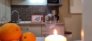 a candle on a table with oranges and a glass at Käuzchennest Klein aber fein ALLES NEU! in Bad Oeynhausen