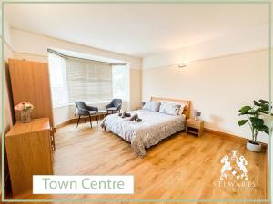 a bedroom with a bed and a table and chairs at Town Centre Apartment Sleeps 9 in Bournemouth