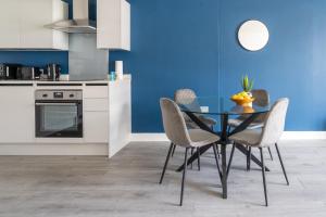 a kitchen with a dining room table and chairs at Indigo Heaven at Hemel in Hemel Hempstead