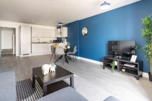 a living room with a blue accent wall at Indigo Heaven at Hemel in Hemel Hempstead
