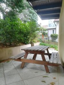 a wooden picnic table sitting on a patio at 3072 Apartment MITTERFELD - Top B in Kasten bei Böheimkirchen