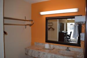 a bathroom with a sink and a mirror at Royal Inn Greenville in Greenville