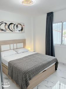 a bedroom with a bed and a large window at San Eugenio in Adeje +12 photos