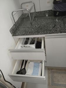 a kitchen counter with a drawer with a utensil at Flat Smart Residence in Teresina