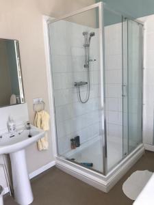 a bathroom with a shower and a sink at Coundon Lodge Coventry in Coventry