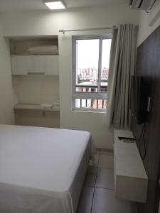 a hotel room with a bed and a window at Flat Smart Residence in Teresina