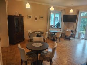 a dining room with two tables and chairs at Lipanka in Lipova Lazne