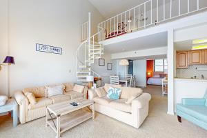 a living room with two couches and a staircase at Sea Colony - 902 Georgetowne House in Bethany Beach