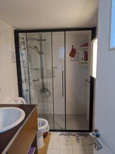 a bathroom with a shower and a sink at Harbor View Haven in Piraeus