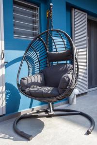 a wicker chair sitting in front of a building at Carmen's cozy&luxury apartment! in Athens