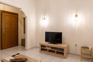 a living room with a flat screen tv on a table at Apartment @Katehaki Metro in Athens