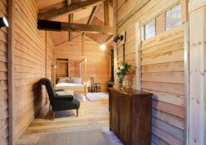 a wooden room with a chair and a table at Dog Crag Cabin in Silecroft