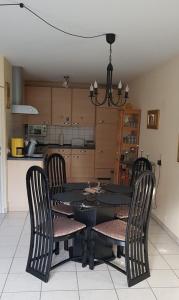 a black dining room table and chairs in a kitchen at Souterrain - a72405 in Rheinbach
