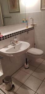 a bathroom with a sink and a toilet at Souterrain in Rheinbach +8 photos