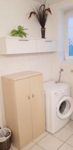 a bathroom with a washing machine and a washer at Souterrain - a72405 in Rheinbach