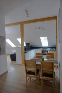 a kitchen with a table and chairs in a room at Ferienwohnung Ottobeuren in Ottobeuren