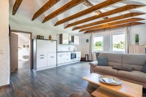 a living room with a couch and a table at Nr 5 Bernuthsfeld mit Loggia in Aurich