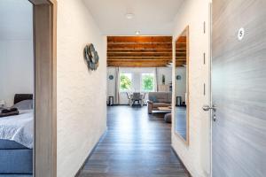 a hallway with a bed and a living room at Nr 5 Bernuthsfeld mit Loggia in Aurich +13 photos