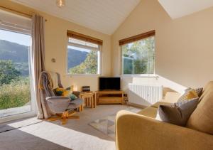 a living room with a couch and a tv at Lingmoor Lookout in Chapel Stile