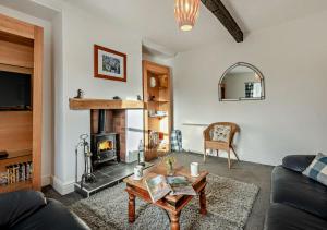 a living room with a couch and a fireplace at Pear Tree Cottage - Solway Coast in Bowness-on-Solway