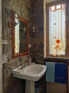 a bathroom with a sink and a window at La Casa Nel Bosco in Beverino