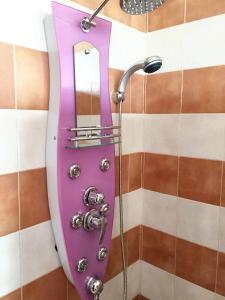 a purple mirror in a shower with a faucet at 4 bedrooms villa at Dar Bouazza Tamaris 200 m away from the beach with private pool and enclosed garden in Dar Bouazza