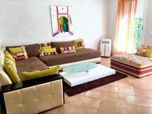 a living room with a couch and a coffee table at 4 bedrooms villa at Dar Bouazza Tamaris 200 m away from the beach with private pool and enclosed garden in Dar Bouazza