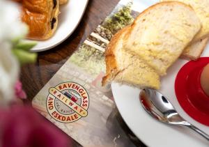 a sandwich on a white plate with a spoon at Irt Pullman Carriage in Ravenglass