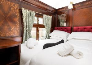 a bedroom with three beds and a desk at Irt Pullman Carriage in Ravenglass