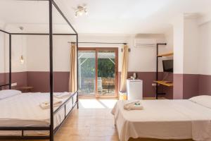 a bedroom with two beds and a balcony at Sea Garden in Kas