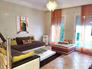 a living room with a couch and a table at Elegant villa in Dar Bouazza with year-round private pool in Dar Bouazza