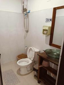 a bathroom with a toilet and a sink at KMJ SUITES in General Luna