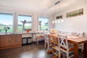 a kitchen and dining room with a table and chairs at Fernblick in Weilheim