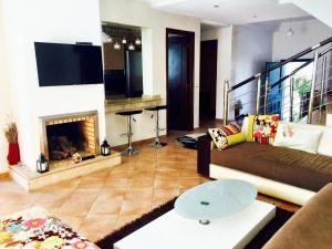 a living room with a couch and a fireplace at 4 bedrooms villa at Dar Bouazza Tamaris 200 m away from the beach with private pool and enclosed garden in Dar Bouazza