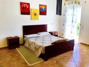 a bedroom with a bed and a couch in it at Elegant villa in Dar Bouazza with year-round private pool in Dar Bouazza