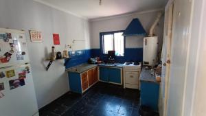a kitchen with blue and white appliances and a refrigerator at Godoy cruz hause in Godoy Cruz
