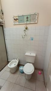 a bathroom with a toilet and a sink at Godoy cruz hause in Godoy Cruz